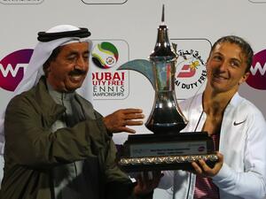Italian tennis player Sara Errani (R) and Sheikh Hasher bin Maktoum, head of the UAE tennis federation, pose with the winner's trophy after Errani beat Czech player Barbora Strycova in the semi-final WTA tennis match of the Dubai Duty Free Tennis Championships, on February 20, 2016. Sara Errani (ITA) beat Barbora Strycova (CZE) 6-0, 6-2