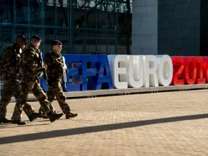 Soldiers walk past giant letters reading "UEFA EURO 2016" as they patrol on February 3, 2016, in Lille, northern France, where some of the Euro 2016 football matches will take place. The upcoming UEFA Euro 2016 European football championship will take place in France from June 10 to July 10, 2016.
PHILIPPE HUGUEN / AFP