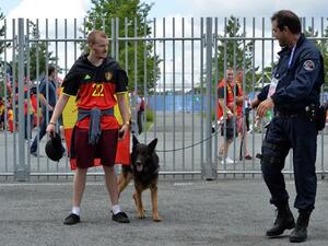 A security guard and his dog inspect a fan ahead of the Euro 2016 group E football match between Belgium and Ireland at the Matmut Atlantique stadium in Bordeaux on June 18, 2016.
NICOLAS TUCAT / AFP