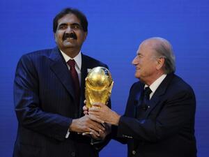 Emir of the State of Qatar Sheikh Hamad bin Khalifa Al-Thani (L) receives the World Cup trophy from Fifa President Joseph Blatter (R) after the official announcement that Qatar will host the 2022 World Cup on December 2, 2010 at the FIFA headquarters in Zurich. AFP PHOTO / PHILIPPE DESMAZES
PHILIPPE DESMAZES / AFP