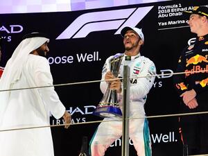 (From L) Ferrari's German driver Sebastian Vettel (2nd), Mercedes' British driver Lewis Hamilton (1st) and Red Bull's Dutch driver Max Verstappen (3rd) celebrate on the podium after the Abu Dhabi Formula One Grand Prix at the Yas Marina circuit on November 25, 2018, in Abu Dhabi.
GIUSEPPE CACACE / AFP