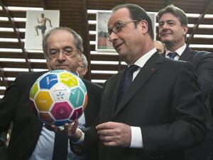 French President Francois Hollande (R) holds a soccer ball next to head of French Football Federation (FFF) Noel Le Graet (L) during his visit to the INSEP or French National Institute of Sport and Physical Education, as part of the government initiative "11 Tricolore, La France au rendez-vous" aimed at promoting top public policies, for the UEFA EURO 2016, in Paris on March 29, 2016.
Michel Euler / POOL / AFP