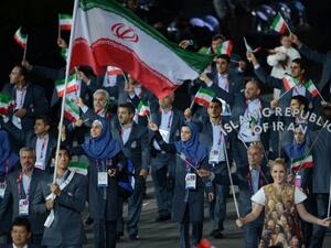 Iran's flagbearer Ali Mazaheri leads his delegation during the opening ceremony of the London 2012 Olympic Games in the Olympic Stadium in London on July 27, 2012. AFP PHOTO / CHRISTOPHE SIMON
CHRISTOPHE SIMON / AFP