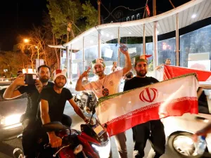 Iranians celebrate on the streets of Tehran early on June 13, 2017, after their national football team won the 2018 World Cup qualifying football match between Iran and Uzbekistan. Iran become the third team assured of a berth in the 2018 World Cup finals along with hosts Russia and Brazil after a 2-0 win over Uzbekistan in Tehran on June 12.
STRINGER / AFP