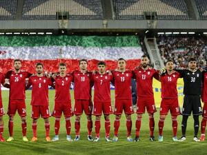 Iran's starting eleven line-up for their national anthem ahead of their international friendly match against Uzbekistan at Tehran's Azadi Stadium on May 19, 2018.
ATTA KENARE / AFP