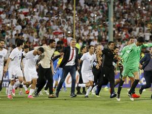 Portuguese coach Carlos Queiroz (C) of the Iranian national football team celebrates among players after winning the 2018 World Cup qualifying football match between Iran and Uzbekistan at the Azadi Stadium in Tehran on June 12, 2017. Iran won 2-0.
ATTA KENARE / AFP