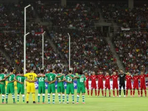 Iraq's (L) and Jordan's starting eleven obeserve a moment of silence ahead of their international friendly football match between Iraq and Jordan at Basra Sports City in Basra on June 1, 2017.
HAIDAR MOHAMMED ALI / AFP