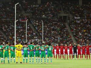 Iraq's (L) and Jordan's starting eleven obeserve a moment of silence ahead of their international friendly football match between Iraq and Jordan at Basra Sports City in Basra on June 1, 2017.
HAIDAR MOHAMMED ALI / AFP