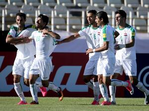 Iraqi players celebrate scoring a goal against Japan's team during their 2018 World Cup qualifying football match between Japan and Iraq at the Dastgherdi Stadium in the Iranian capital Tehran on June 13, 2017.
ATTA KENARE / AFP