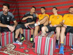 (from L to R) Juventus' Italian goalkeeper Gianluigi Buffon, Italian goalkeeper Emil Audero, German midfielder Sami Khedira, Swiss defender Stephan Lichtsteiner, and Italian defender Andrea Barzagli gather after a training session in Doha on December 21, 2016, two days before the Italian Super Cup final football match between Juventus and AC Milan in the Qatari capital.
KARIM JAAFAR / AFP