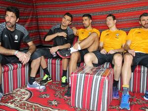 (from L to R) Juventus' Italian goalkeeper Gianluigi Buffon, Italian goalkeeper Emil Audero, German midfielder Sami Khedira, Swiss defender Stephan Lichtsteiner, and Italian defender Andrea Barzagli gather after a training session in Doha on December 21, 2016, two days before the Italian Super Cup final football match between Juventus and AC Milan in the Qatari capital.
KARIM JAAFAR / AFP