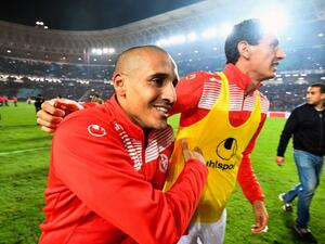 Tunisian footballers Wahbi Khazri (C-L) and Karim Awadhi (C-R) celebrate on the pitch after qualifying for the 2018 World Cup finals after drawing their qualifiers match against Libya at the Rades Olympic Stadium in the capital Tunis on November 11, 2017.
FETHI BELAID / AFP