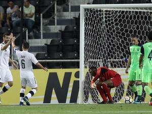 Al-Sadd's captain Xavi (C) celebrates with his teammate Boualem Khouakhi (L) after they scored a goal during the AFC Champions League football match between Qatar's Al-Sadd club and Saudi's Al-Ahli team at the Jassim Bin Hamas Stadium in Doha on May 7, 2018.
KARIM JAAFAR / AFP