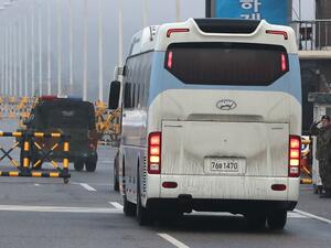 A bus carrying a delegation of South Korean officials passes a military check point on the road leading to the border truce village of Panmunjom in Paju on January 15, 2018. North and South Korea began talks on January 15 on appearances by Pyongyang's state-run artistic performers at next month's Winter Olympics in the South, after the North agreed to attend the Games.

YONHAP / AFP