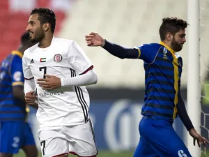 UAE's Al-Jazira's Ali Ahmed Mabkhout (L) celebrates after scoring against Qatar's al-Gharafa's Rubert Fasciana (R) during the AFC Champions League Round 1 Group (A) Match between al-Jazira vs al-Gharafa at the Mohammed Bin Zayed Stadium in abu Dhabi on February 12, 2018.
NEZAR BALOUT / AFP