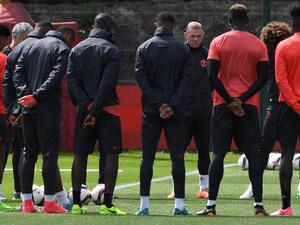 Manchester United's English striker Wayne Rooney (4R) stands with teammates as they observe a minute's silence for the victims of yesterday's terror attack at the Ariana Grande concert at the Manchester Arena, during a team training session at the club's training complex near Carrington, west of Manchester in north west England on May 23, 2017, ahead of their UEFA Europa League final football match against Ajax.
Paul ELLIS / AFP