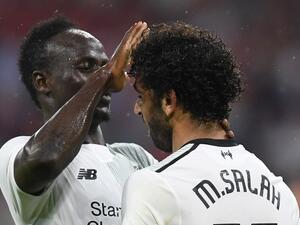 Liverpool's Senegalese striker Sadio Mane (L) and his teammate Liverpool's Egyptian striker Mohamed Salah (R) react after the second goal for Liverpool during the second Audi Cup football match between FC Bayern Munich and FC Liverpool in the stadium in Munich, southern Germany, on August 1, 2017.
Christof STACHE / AFP