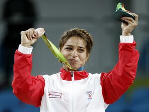 Tunisia's bronze medallist Marwa Amri reacts on the podium at the end of the women's 58kg freestyle wrestling event at the Carioca Arena 2 in Rio de Janeiro on August 17, 2016, during the Rio 2016 Olympic Games. Jack GUEZ / AFP