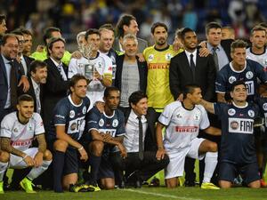 Match For Peace's Argentinian defender Javer Zanetti (C white up) holds the trophy with Match For Peace's players team at the end of their intereligious " Match for Peace " football game on September 1, 2014 at Rome's Olympic stadium. AFP PHOTO / ANDREAS SOLARO