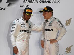Mercedes' British driver Lewis Hamilton (L) and Mercedes' Finnish driver Valtteri Bottas stand on the podium after Ferrari's German driver Sebastian Vettel won the Bahrain Formula One Grand Prix at the Sakhir circuit in Manama on April 16, 2017.
ANDREJ ISAKOVIC / AFP