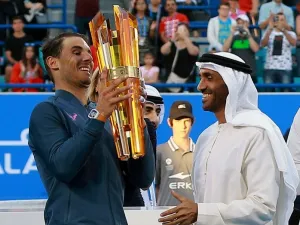 Spain's Rafael Nadal receives his trophy from Sheikh Nahyan bin Zayed al-Nahyan, Chairman of Abu Dhabi Sports Council, after defeating Belgium's David Goffin in the final match of the Mubadala World Tennis Championship 2016 in Abu Dhabi on December 31, 2016.
NEZAR BALOUT / AFP