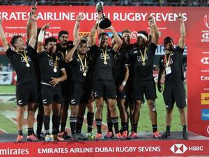 New Zealand's players celebrate with the trophy of the Men's Sevens World Rugby Dubai Series Cup after the Final match between USA an New Zealand on December 01, 2018.
KARIM SAHIB / AFP
