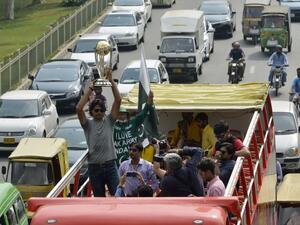 Pakistani cricketer Mohammad Irfan holds the 2019 ICC Cricket World Cup trophy atop a bus during a parade event in Lahore on October 3, 2018. The 2019 Cricket World Cup is the scheduled to be hosted by England and Wales from May 30th to July 14th of 2019.
ARIF ALI / AFP