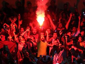 Persepolis fans cheer during the Asian Champions League football match between UAE's Al-Wahda and Iran's Persepolis at the Azadi Stadium in Tehran on May 8, 2017.
ATTA KENARE / AFP