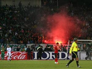 Egyptian fans of Al-Masry light flares during a football match against Al-Ahly in Port Said on February 1, 2012. At least 74 people were killed and hundreds injured when rival fans clashed after the football match, highlighting a security vacuum in post-revolution Egypt. AFP PHOTO/STR
STR / AFP