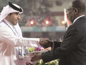 Secretary-General of QOC Thani Abdulrahman al-Kuwari (left) receives the flag from President of the Asian Athletics Association and Vice President of the IAAF Dahlan al-Hamad for the 2019 edition of the Asian Athletics Championships, which Doha will host. (Photo: Gulf Times)