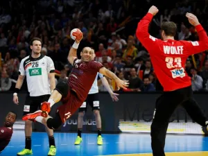 Qatar's pivot Bassel Alrayes (L) jumps to shoot on goal against Germany's goalkeeper Andreas Wolff during the 25th IHF Men's World Championship 2017 eighth final handball match Germany vs Qatar on January 22, 2017 at the AccorHotels Arena in Paris.
THOMAS SAMSON / AFP