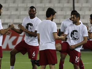 Qatar's national team players wear t-shirts bearing portraits of Emir Sheikh Tamim bin Hamad Al-Thani, in support the Qatari leader in the ongoing diplomatic crisis surrounding Qatar and other Gulf countries as they warm up prior to their World Cup 2018 Asia qualifying football match between Qatar and South Korea at the Jassim Bin Hamad stadium in Doha on June 13, 2017.
KARIM JAAFAR / AFP