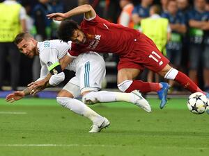 Liverpool's Egyptian forward Mohamed Salah (R) falls with Real Madrid's Spanish defender Sergio Ramos leading to Salah being injured during the UEFA Champions League final football match between Liverpool and Real Madrid at the Olympic Stadium in Kiev, Ukraine, on May 26, 2018.
GENYA SAVILOV / AFP