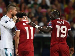 Liverpool's Egyptian forward Mohamed Salah (C) reacts as he leaves the pitch after an injury while Liverpool's Senegalese midfielder Sadio Mane (R) and Real Madrid's Spanish defender Sergio Ramos (L) comforts him during the UEFA Champions League final football match between Liverpool and Real Madrid at the Olympic Stadium in Kiev, Ukraine, on May 26, 2018.
FRANCK FIFE / AFP