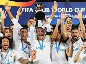 Real Madrid's players celebrate with the FIFA Club World Cup trophy following their victory in the final football match against Gremio FBPA at the Zayed Sports City Stadium in Abu Dhabi on December 16, 2017. Real Madrid defeated Gremio 1-0 to lift the FIFA Club World Cup for the third time in their history.
KARIM SAHIB / AFP