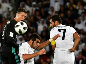 Real Madrid's Portuguese forward Cristiano Ronaldo (L) vies for the header with al-Jazira's Emirati defender Musallem Fayez (C) and Emirati forward Ali Mabkhout (R) during the FIFA Club World Cup semi-final match in the Emirati capital Abu Dhabi on December 13, 2017.
GIUSEPPE CACACE / AFP