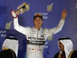 Mercedes AMG Petronas German driver Nico Rosberg holds up his trophy as he celebrates on the podium after taking third place in the Formula One Bahrain Grand Prix at the Sakhir circuit in the desert south of the Bahraini capital, Manama, on April 19, 2015. AFP PHOTO / MARWAN NAAMANI
MARWAN NAAMANI / AFP