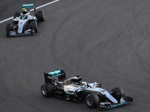 Mercedes AMG Petronas F1 Team's British driver Lewis Hamilton (R) and his teammate German driver Nico Rosberg steer their cars during the Abu Dhabi Formula One Grand Prix at the Yas Marina circuit on November 27, 2016. KARIM SAHIB / AFP