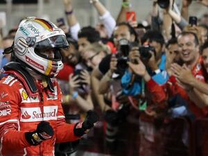 Ferrari's German driver Sebastian Vettel celebrates after winning the Bahrain Formula One Grand Prix at the Sakhir circuit in Manama on April 16, 2017
KARIM SAHIB / AFP