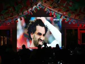 Egyptian striker Mohamed Salah's face is seen on a screen as people watch the Russia 2018 World Cup Group A football match between Russia and Egypt on June 19, 2018 in Kuwait City.
Yasser Al-Zayyat / AFP