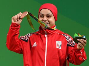 Egypt's Sara Ahmed poses with her bronze medal on the podium of the Women's 69kg weightlifting competition at the Rio 2016 Olympic Games in Rio de Janeiro on August 10, 2016.
GOH Chai Hin / AFP