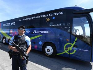 A policeman stands guard as Switzerland's national football team leaves Montpellier's airport by bus, on June 6, 2016, four days ahead of the start of the Euro 2016 European football championships.
PASCAL GUYOT / AFP