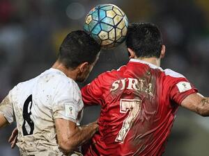Omar Khrbin of Syria (R) and Morteza Pouraliganji of Iran head the ball during the 2018 World Cup qualifying football match between Syria and Iran at Tuanku Abdul Rahman Stadium in Seremban on November 15, 2016.
MOHD RASFAN / AFP