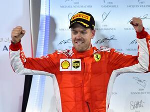 Ferrari's German driver Sebastian Vettel celebrates after winning the Bahrain Formula One Grand Prix at the Sakhir circuit in Manama on April 8, 2018.
GIUSEPPE CACACE / AFP