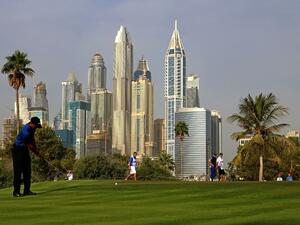 Tiger Woods of the United States follows his ball after playing a shot during the Dubai Desert Classic golf tournament at the Emirates Golf Club in Dubai on February 2, 2017.
NEZAR BALOUT / AFP