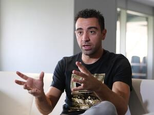 Xavi Hernandez, who currently plays for the Qatari football club Al-Sadd, speaks to journalists during a tour of the Khalifa International Stadium in Doha on May 18, 2017, after it was refurbished ahead of the Qatar 2022 FIFA World Cup. KARIM JAAFAR / AFP