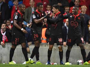 Nice's Algerian defender Youcef Atal (C) is congratulated by his teammates after scoring a goal during the French L1 football match between Nîmes and Nice, on November 10, 2018 at the Costières stadium in Nîmes, southern France.
PASCAL GUYOT / AFP