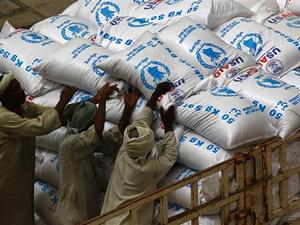 Sudanese workers offload US aid destined for South Sudan from the World Food Programme . (AFP/ File Photo)