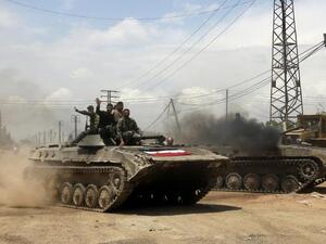 Syrian troops celebrate as they take control of the village of Western Dumayna, some seven kilometers north of the rebel-held city of Qusayr, on May 13 (Joseph Eid/ AFP)