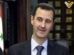 An image grab taken on May 30, 2013 from Lebanon's Shiite Muslim party Hezbollah's al-Manar TV shows Syrian President Bashar al-Assad smiles as she speaks during an interview with al-Manar in Damascus (al-Manar/ AFP)